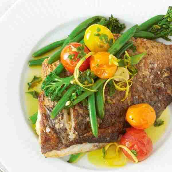 Crispy-skinned barramundi with garlic and herb oil
