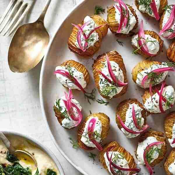 Mini hasselbacks with soured cream, dill & pink pickled onions