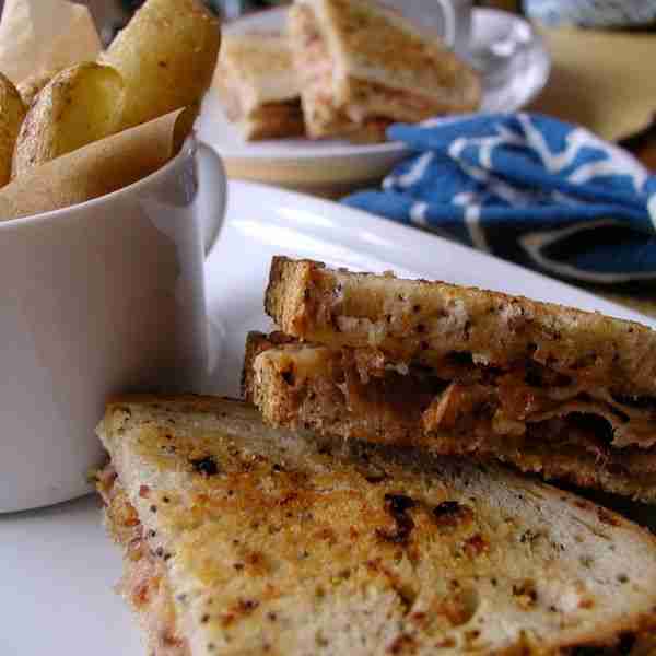 “Sweet Heat” Grilled Prosciutto and Smoked Gouda Sandwich (with spicy plum chutney and crispy onions)